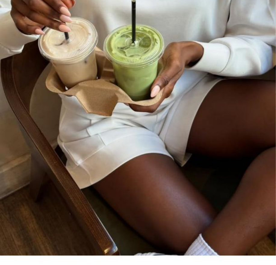 Person holding tray with iced coffee and matcha drinks